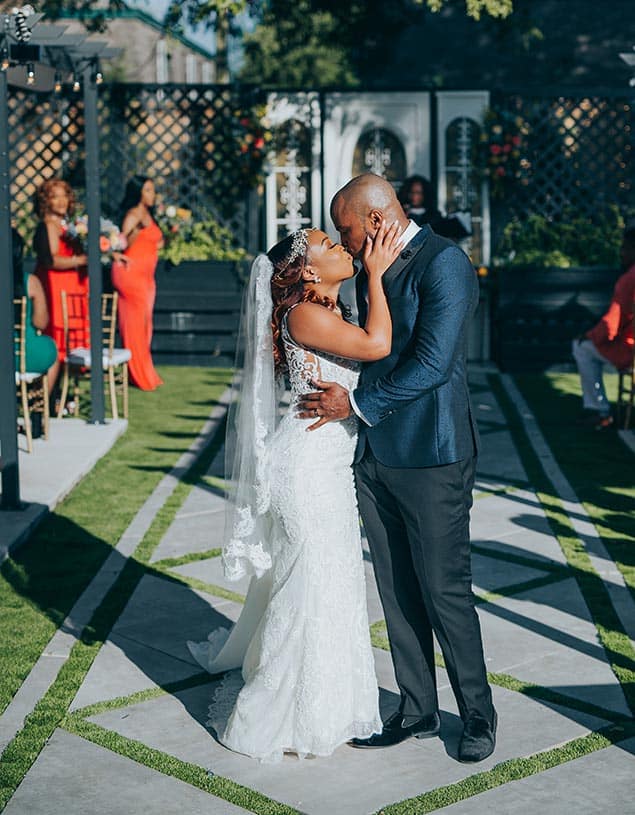 Wedding couple kissing in the gardens at The Gaston, Dallas Wedding Venue